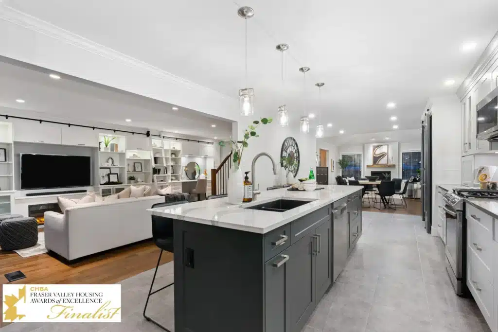 Modern kitchen interior featuring sleek cabinetry, a central island with a sink, and stylish pendant lighting, showcasing a blend of functionality and contemporary design, emphasizing sustainable materials in the context of kitchen renovations.